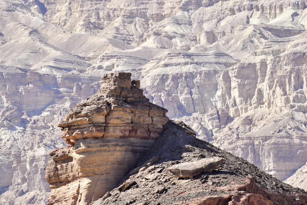 a mountain with a large rock formation in the foreground