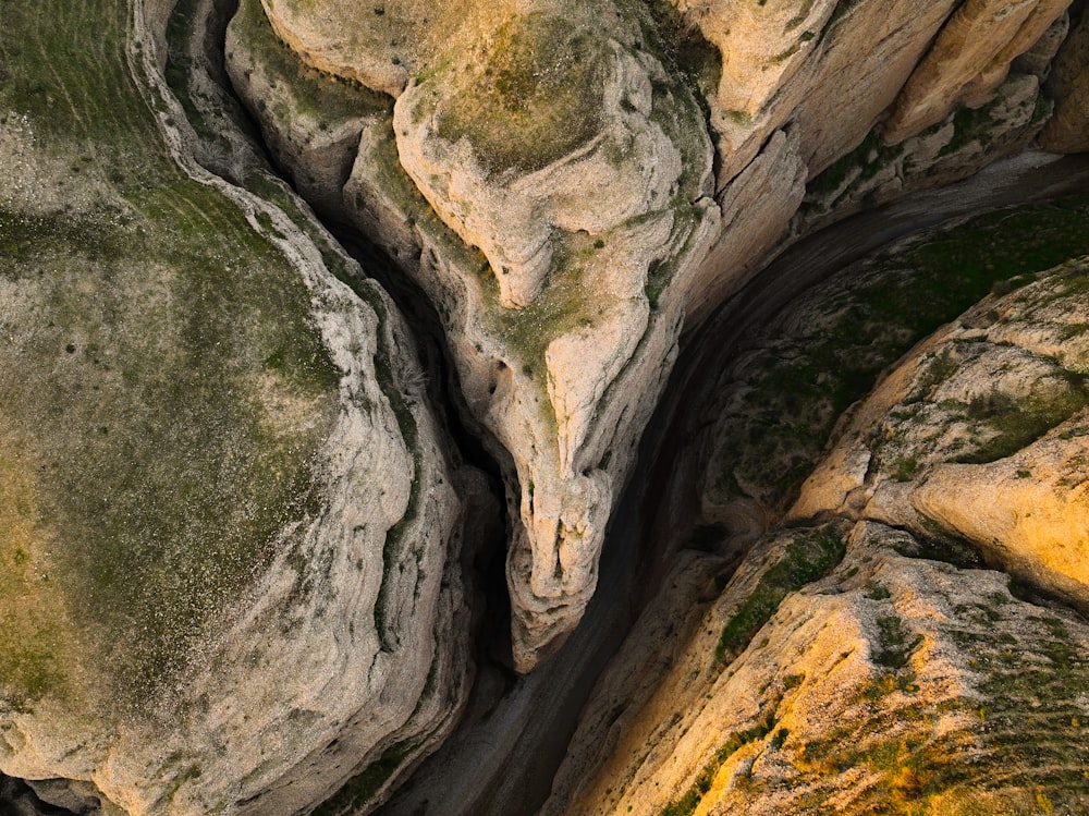 an aerial view of a river running between two large rocks