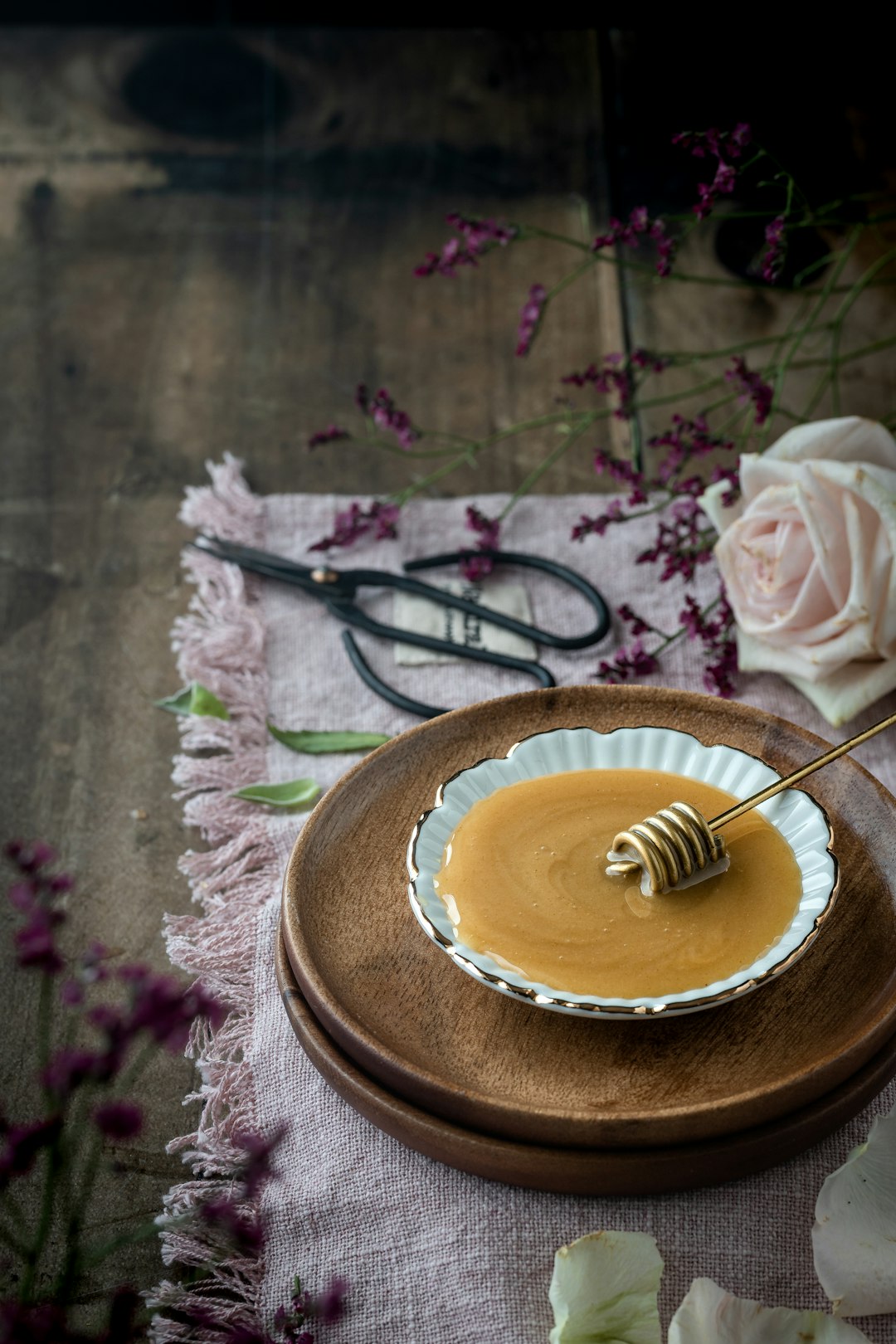 a plate with a honey dip and a pair of scissors