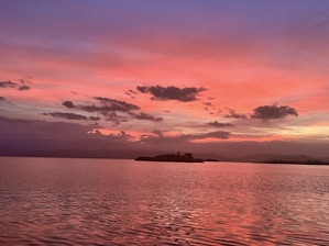 Sunset over Island Lake with the villa silhouetted against the colorful sky.