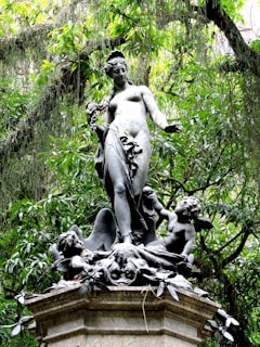 a statue of a woman surrounded by birds
