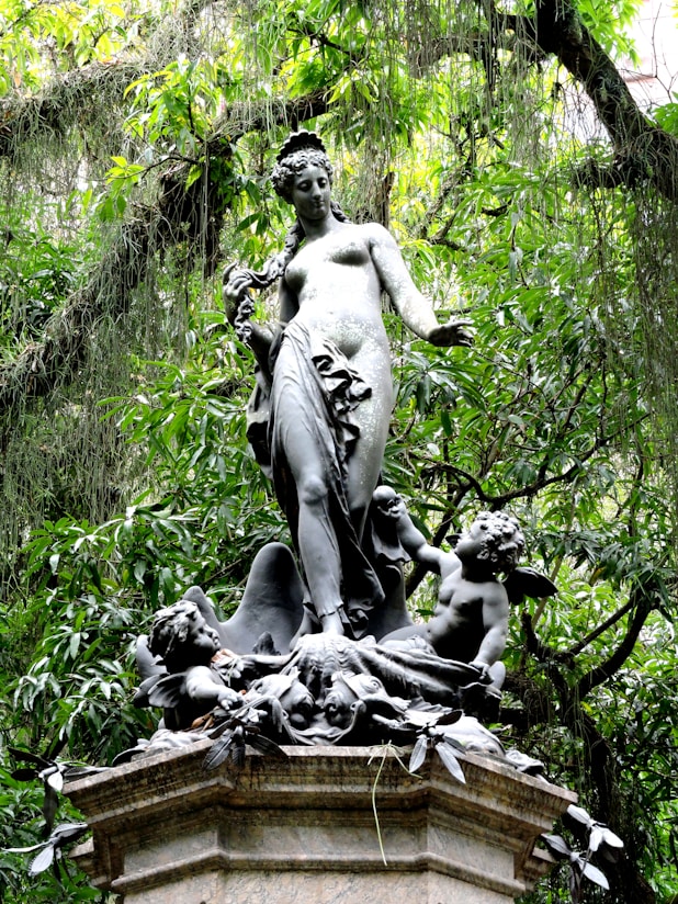 a statue of a woman surrounded by birds