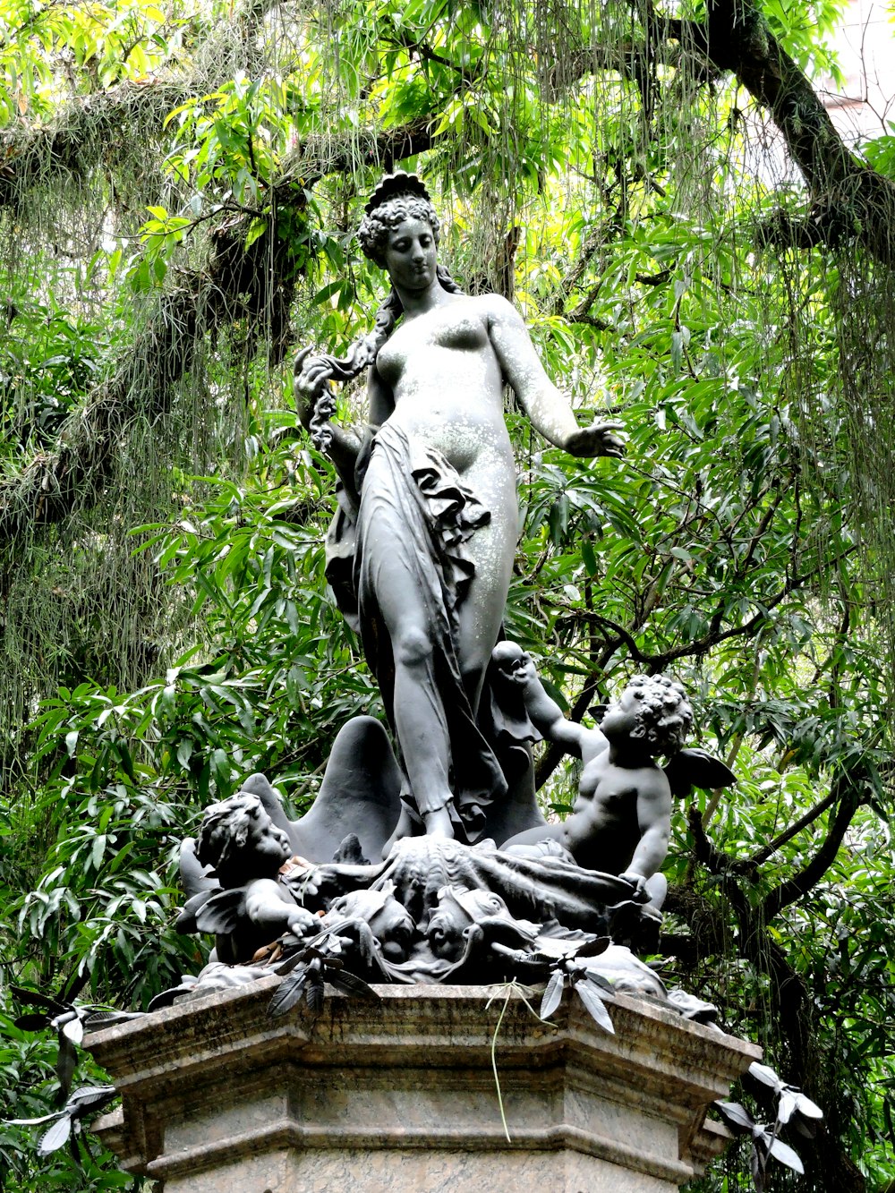 a statue of a woman surrounded by birds