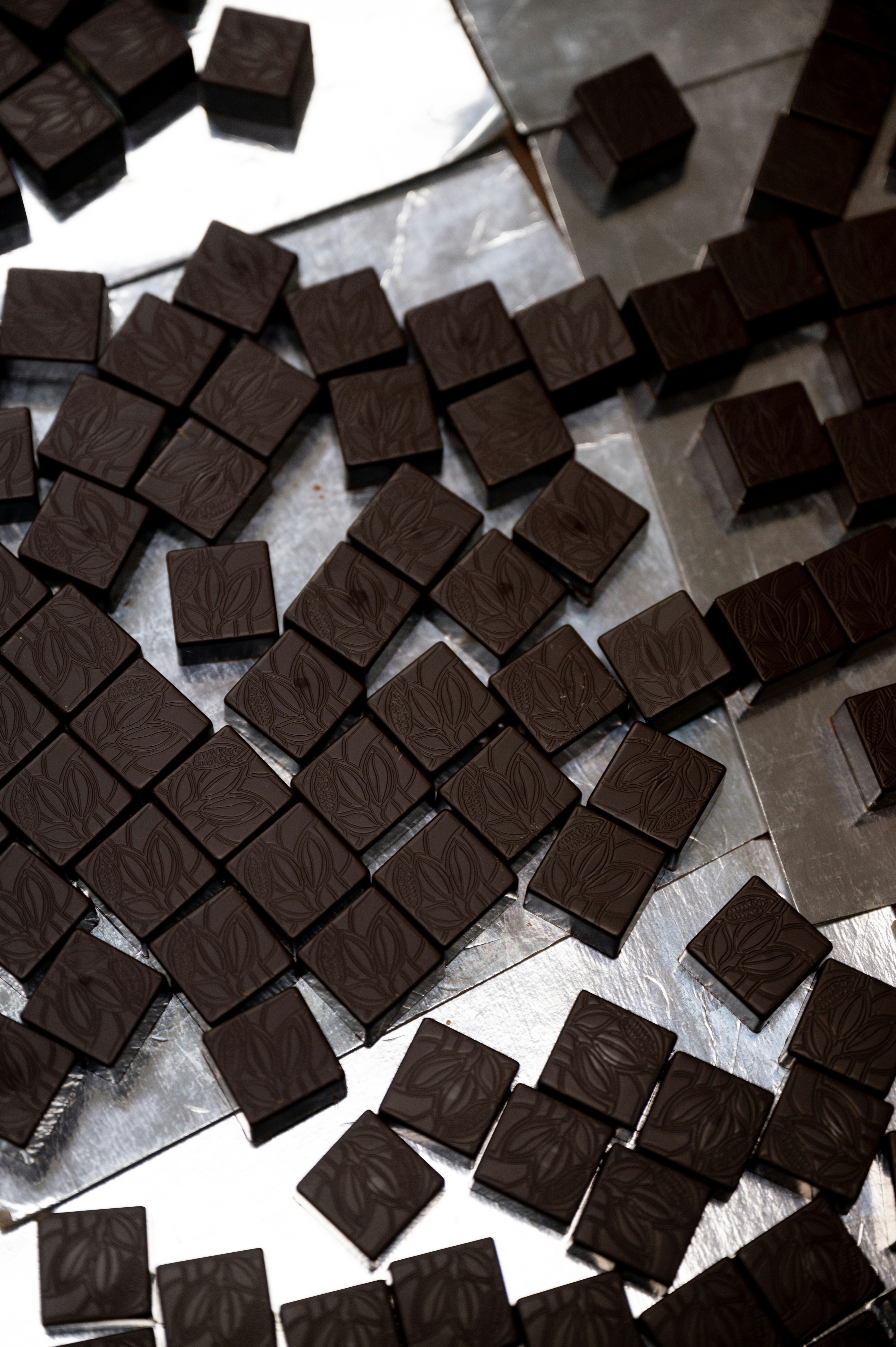a pile of chocolate squares sitting on top of a table
