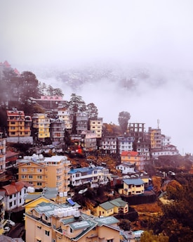 a view of a city in the middle of a foggy day