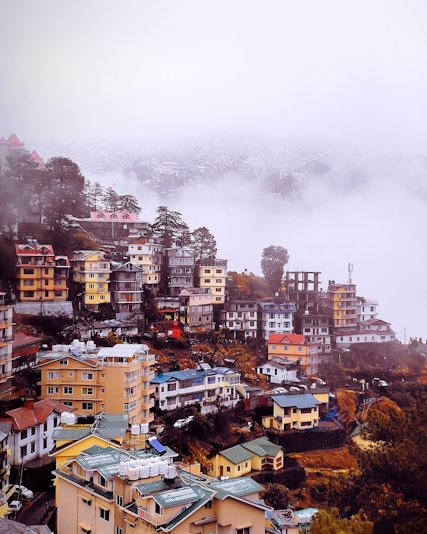 a view of a city in the middle of a foggy day