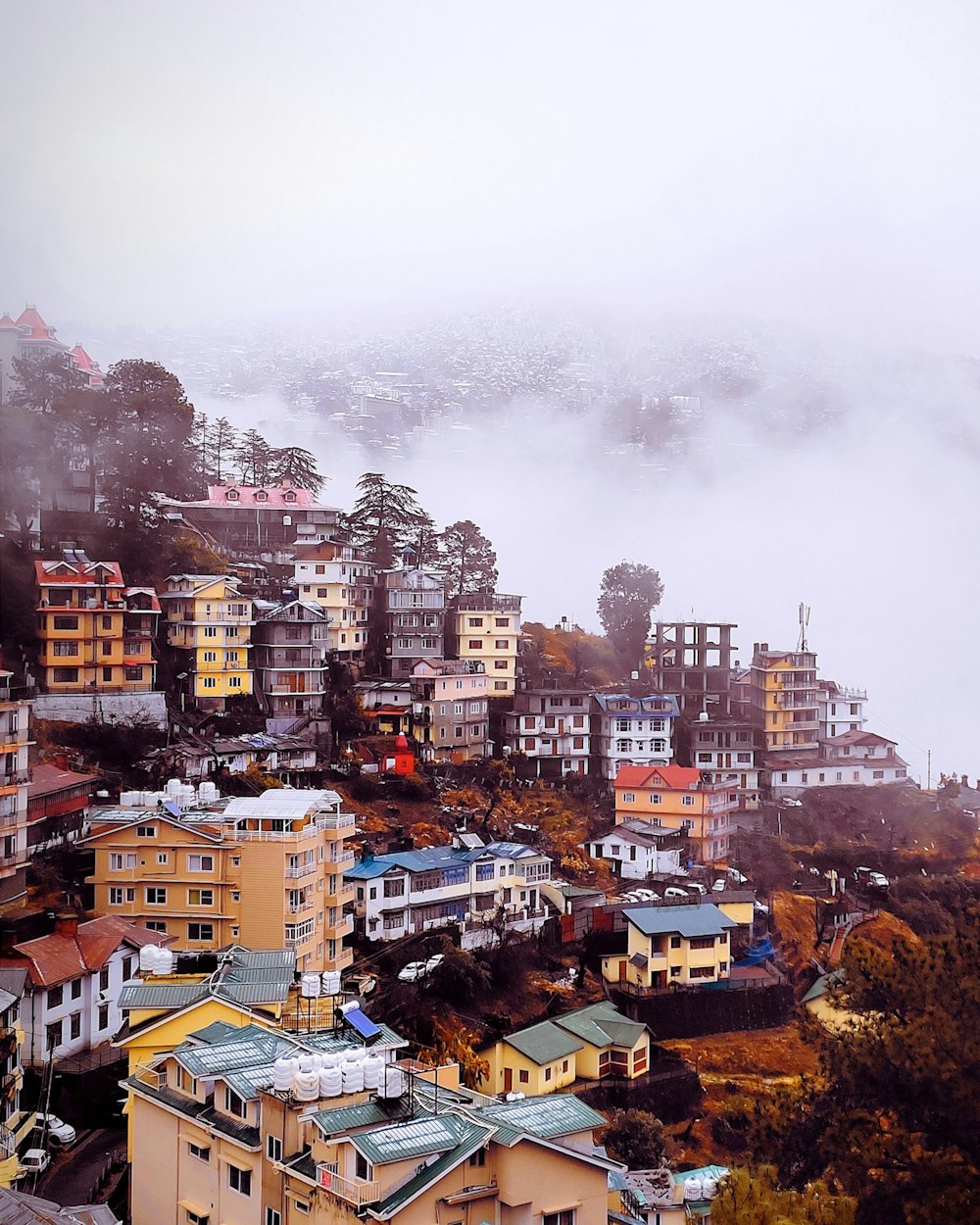 a view of a city in the middle of a foggy day