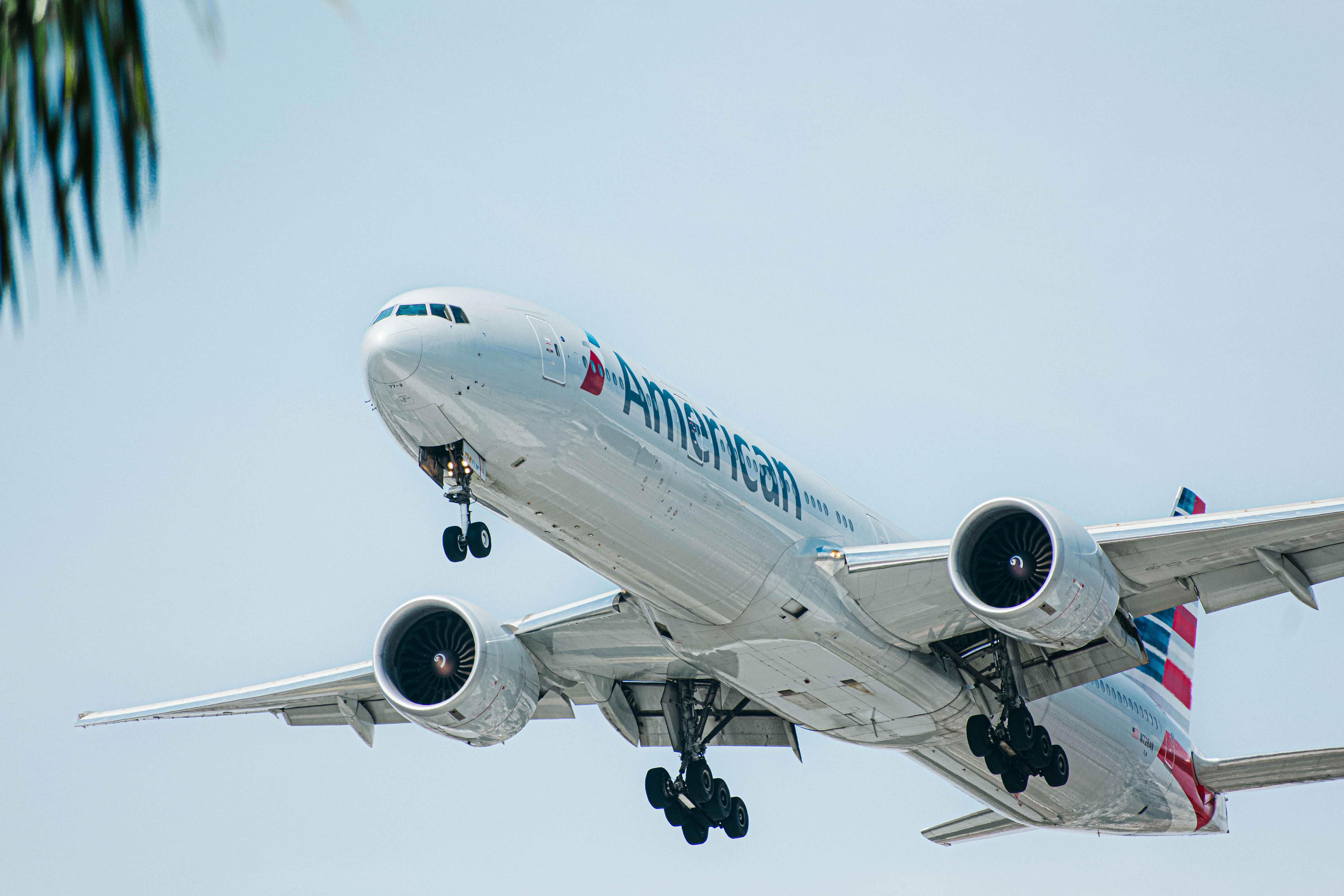 a large passenger jet flying through a blue sky, 