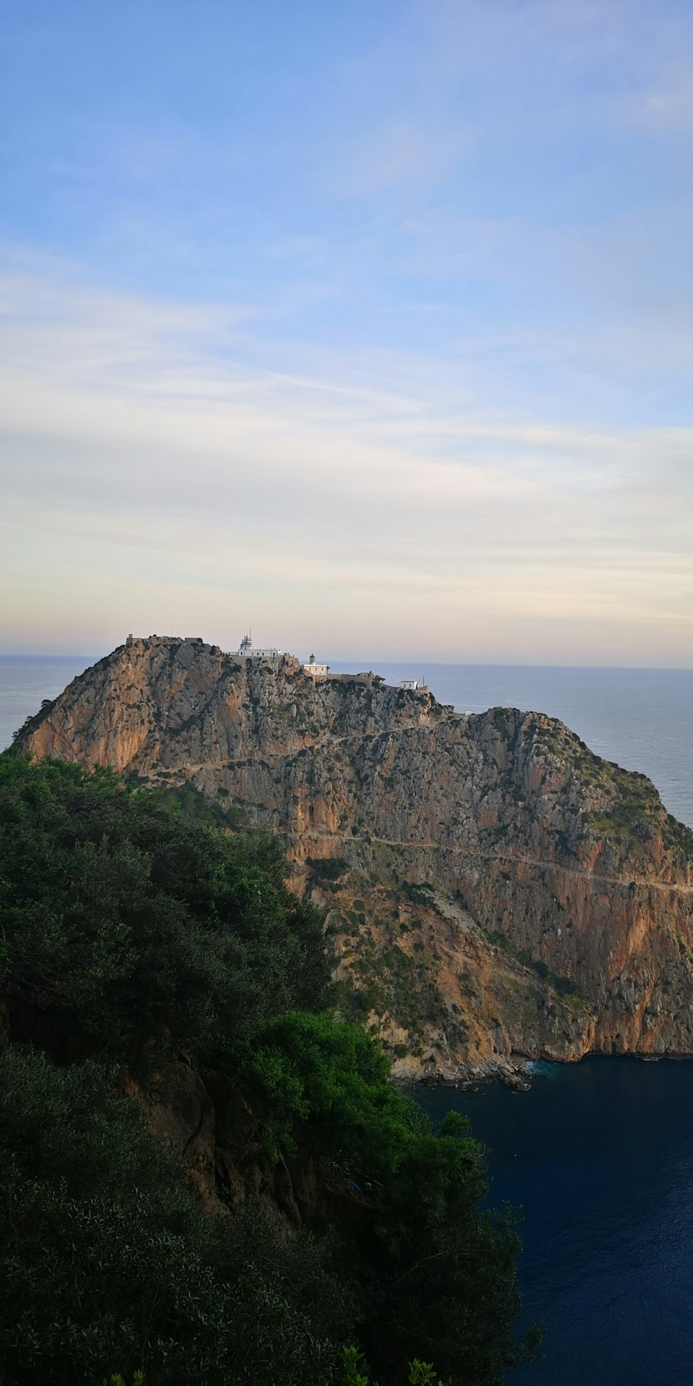 a hill with a small house on top of it