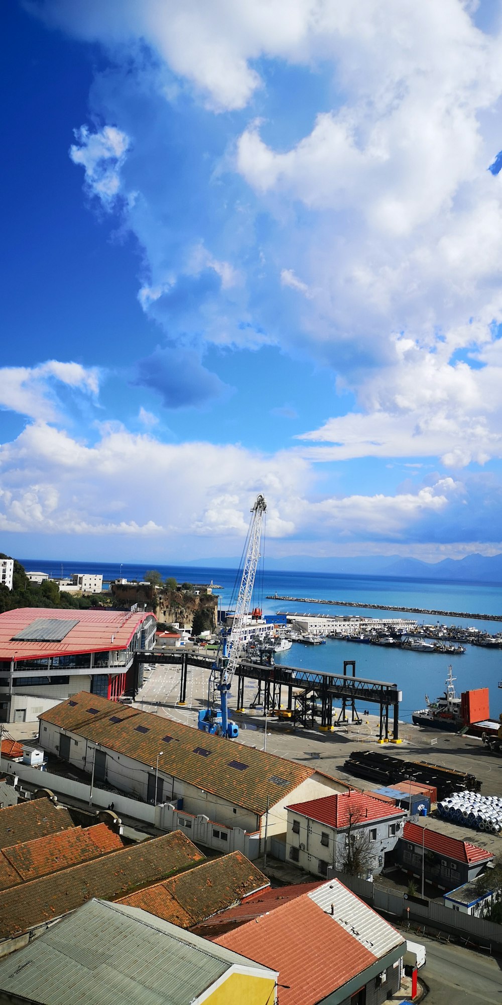 a view of a harbor with a crane in the distance