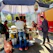 A happy customer enjoying a vibrant taco at an outdoor food stall on a sunny day.
