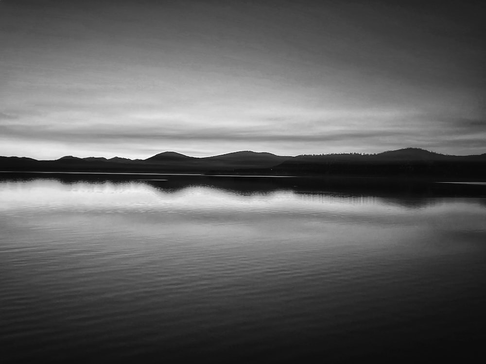 a body of water with mountains in the background