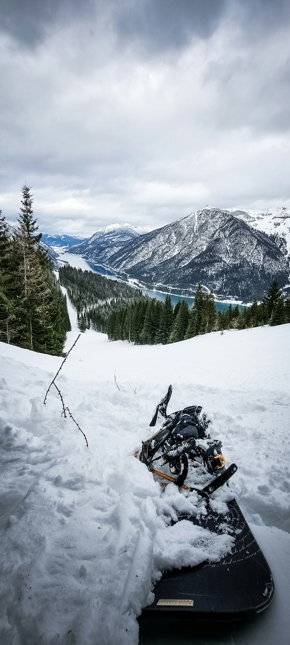 a snowboard that is laying in the snow