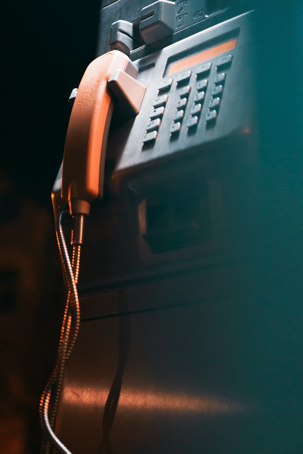 a close up of a phone with a cord attached to it