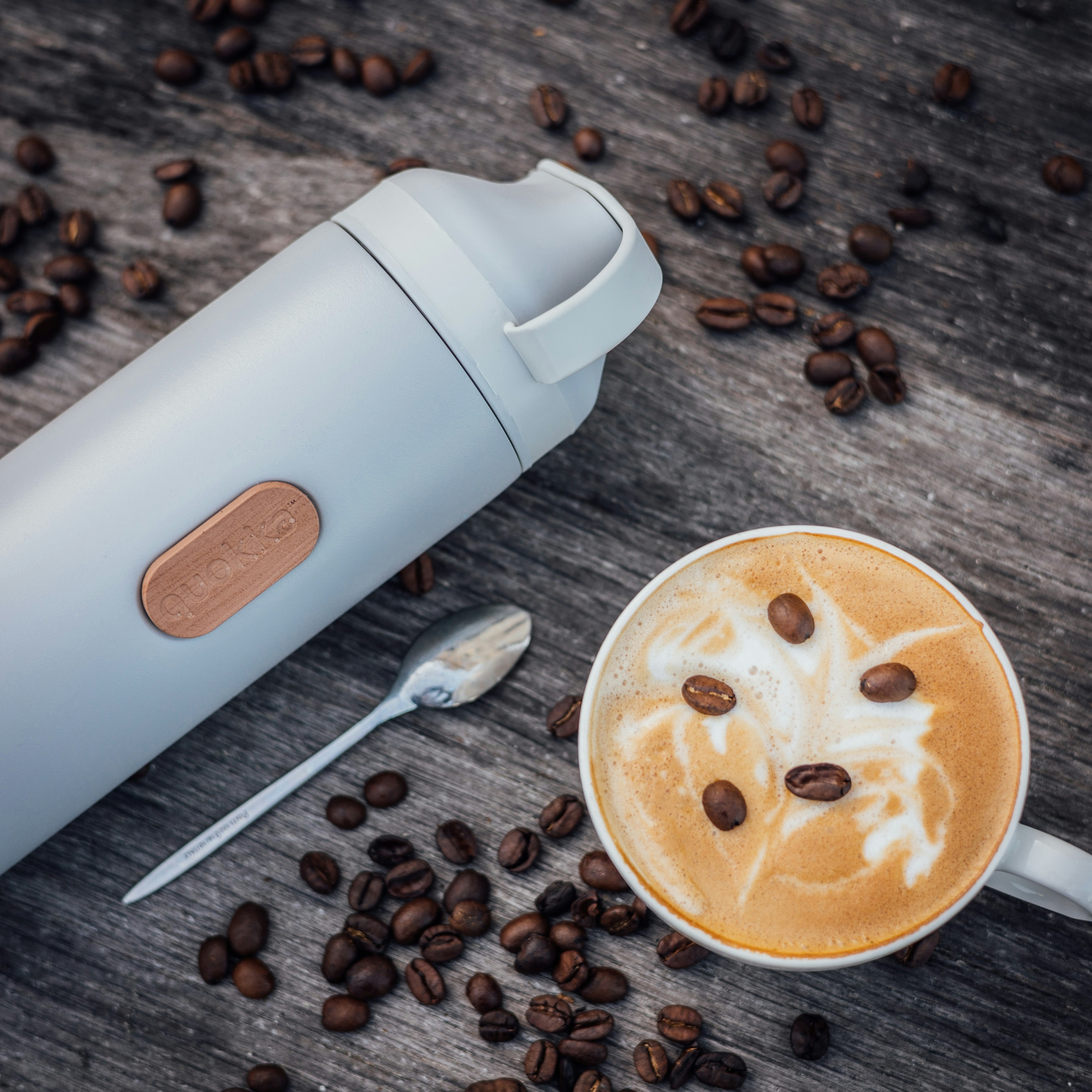 a cup of coffee with a face drawn on it