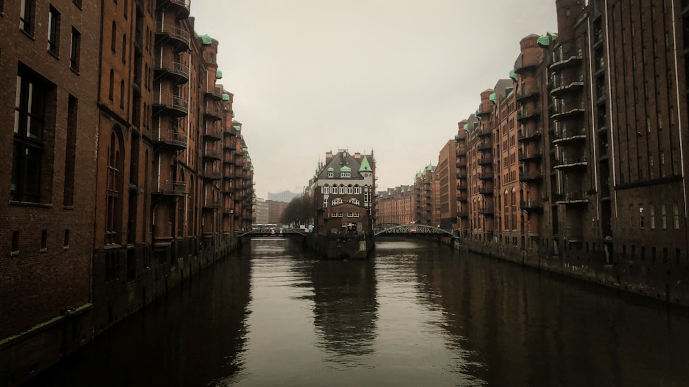 a river running through a city next to tall buildings