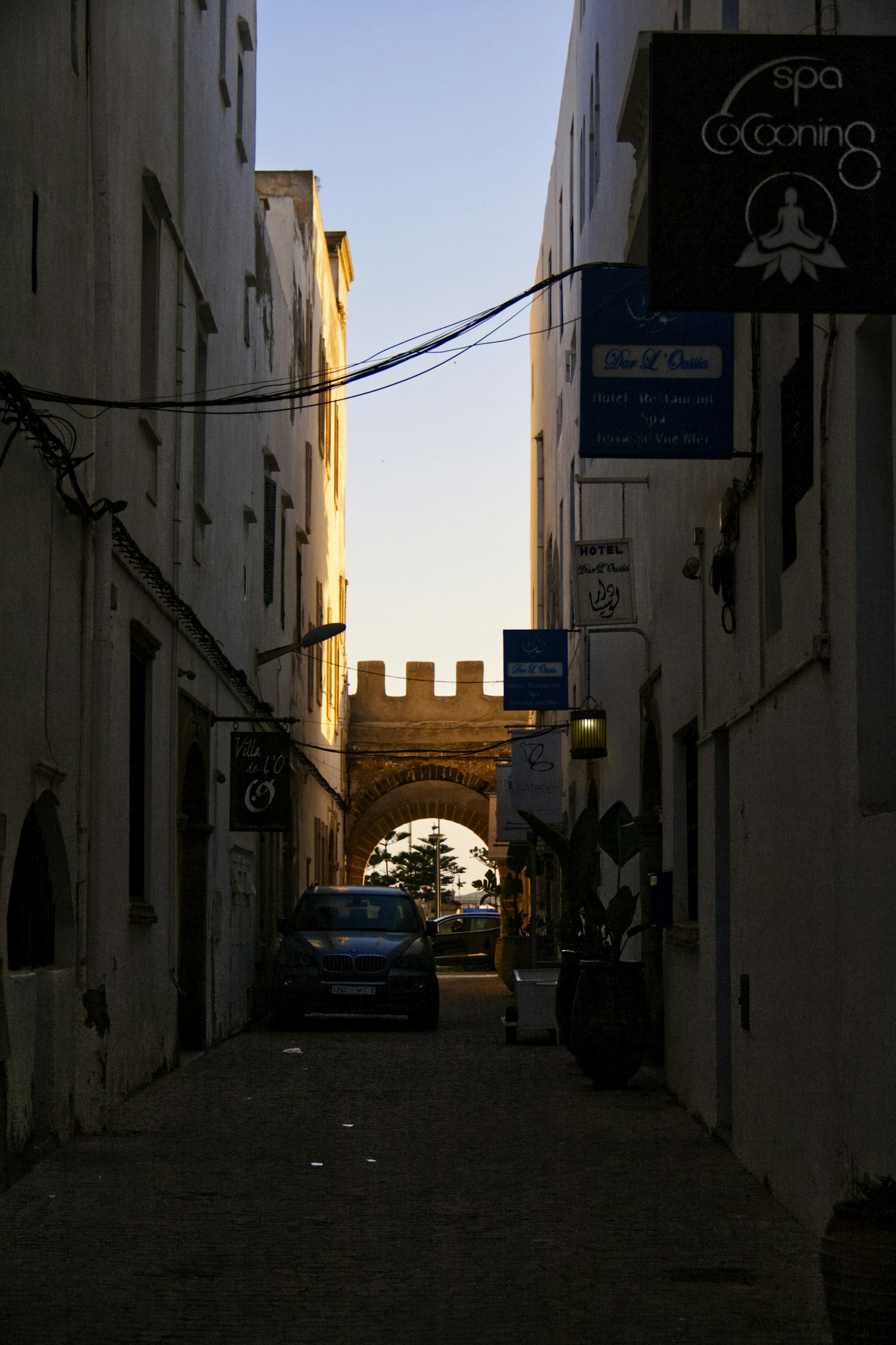 a car is parked on a narrow street