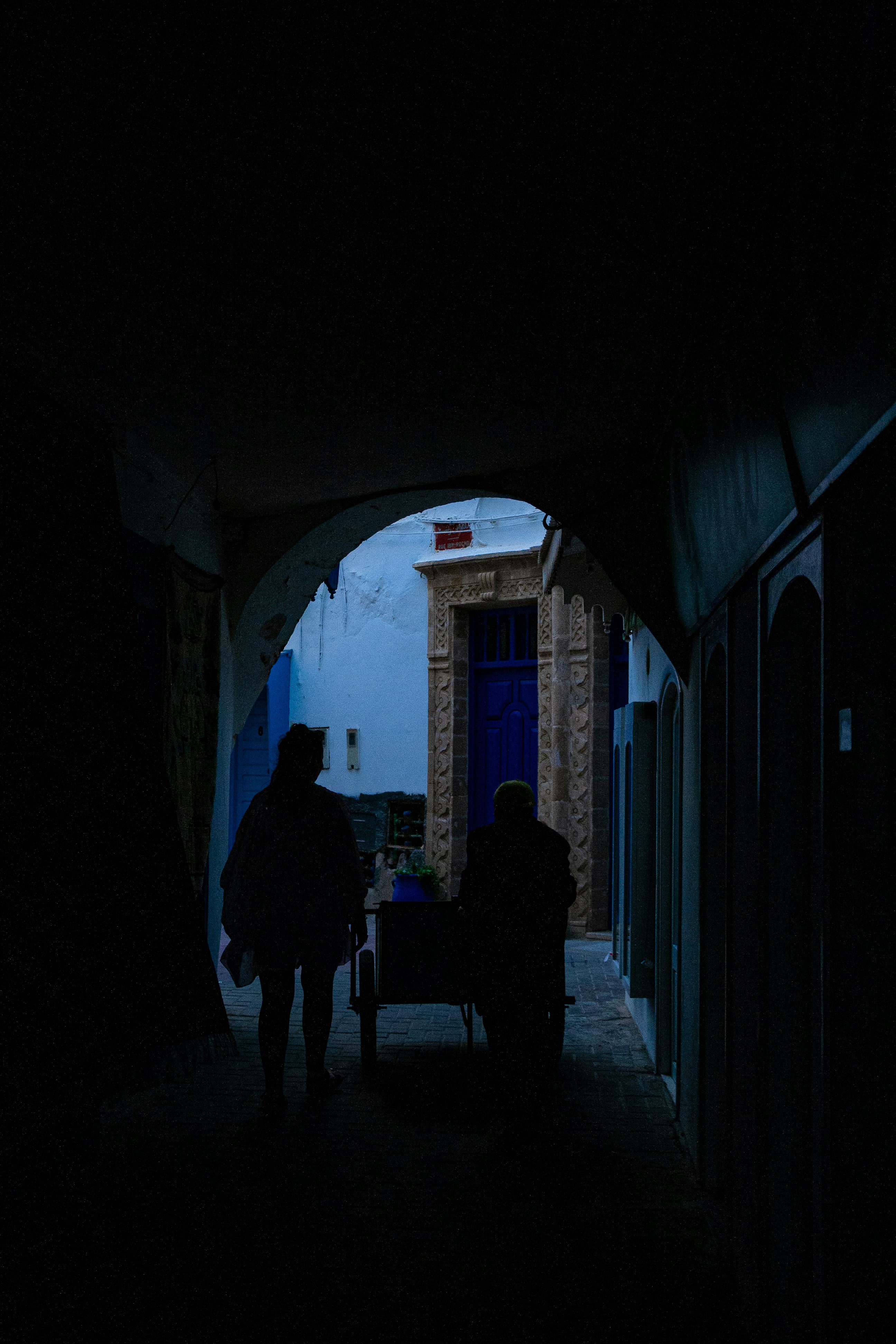 a couple of people that are standing in the dark