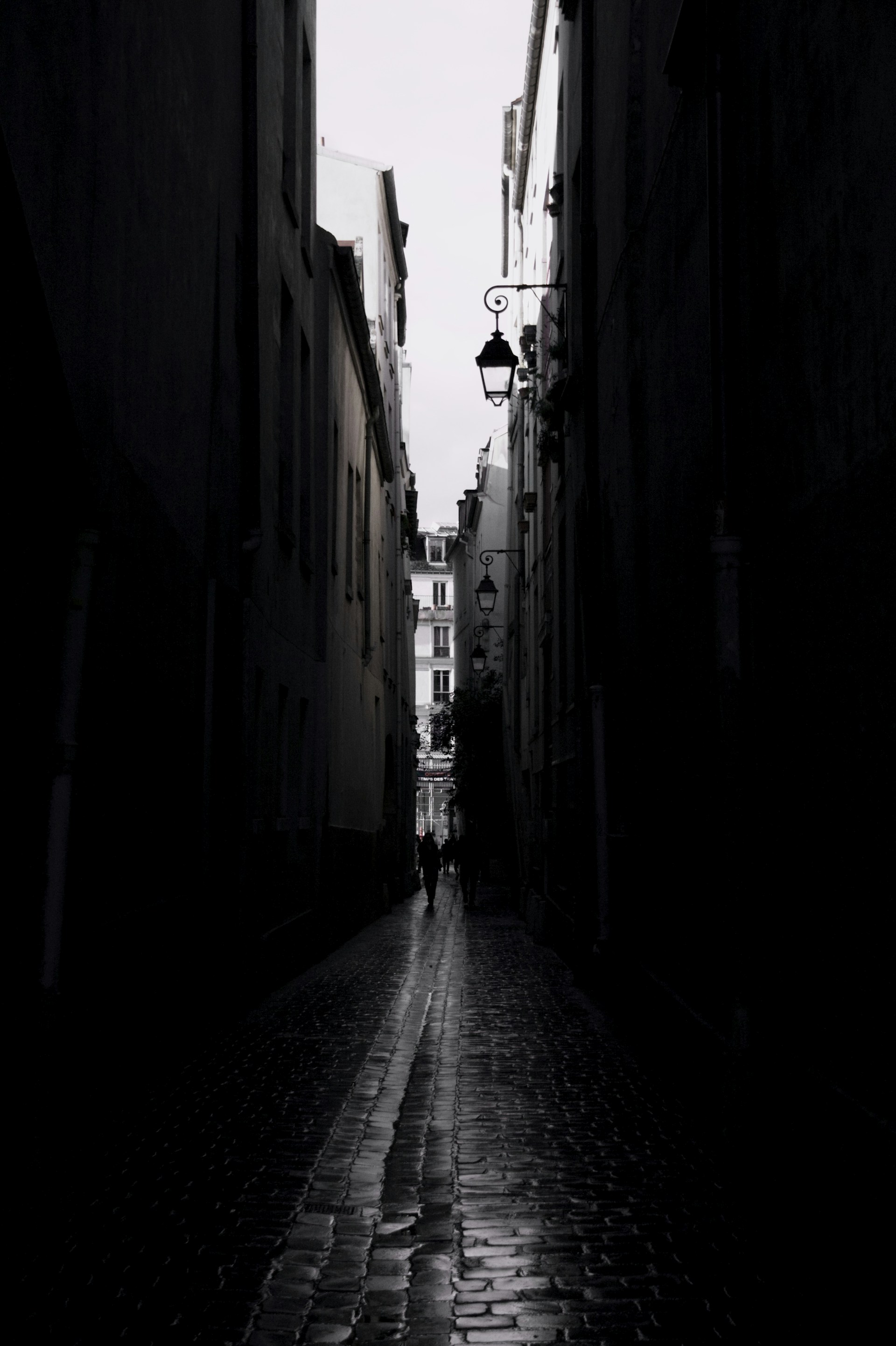 a person walking down a dark alley way