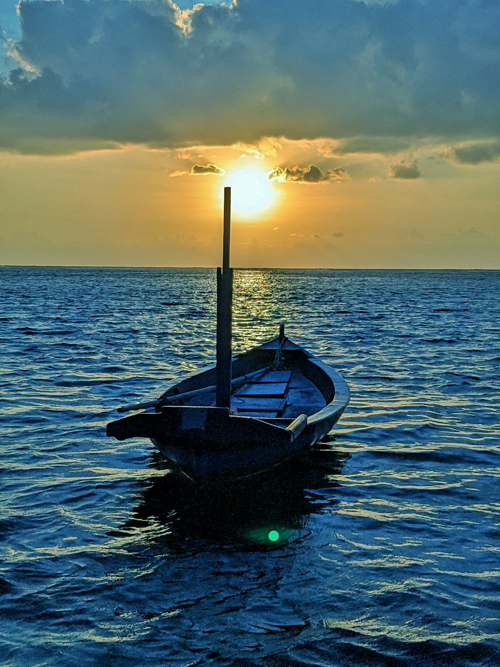 a small boat floating on top of a large body of water