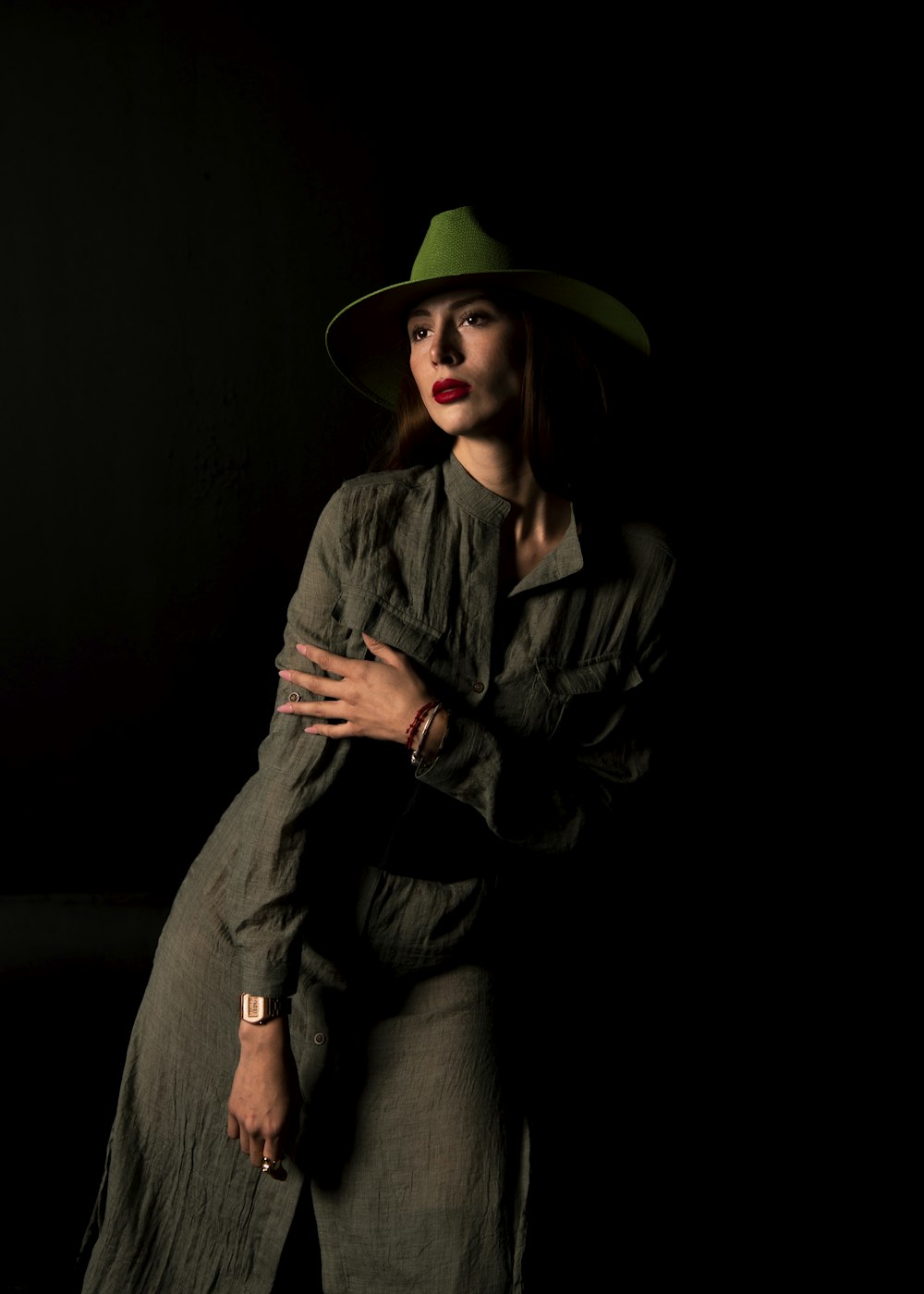 a woman wearing a green hat and dress