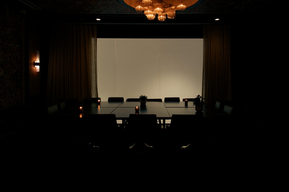 a dimly lit conference room with a chandelier