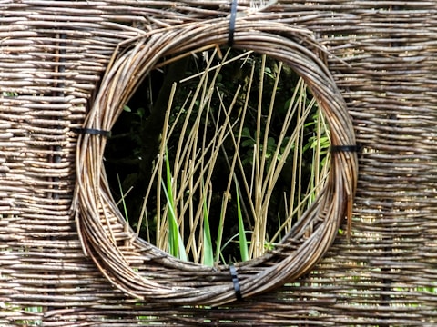 a round mirror hanging on the side of a wall