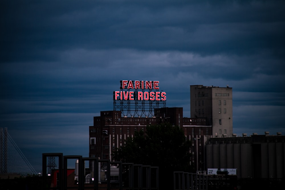 a large neon sign on top of a building