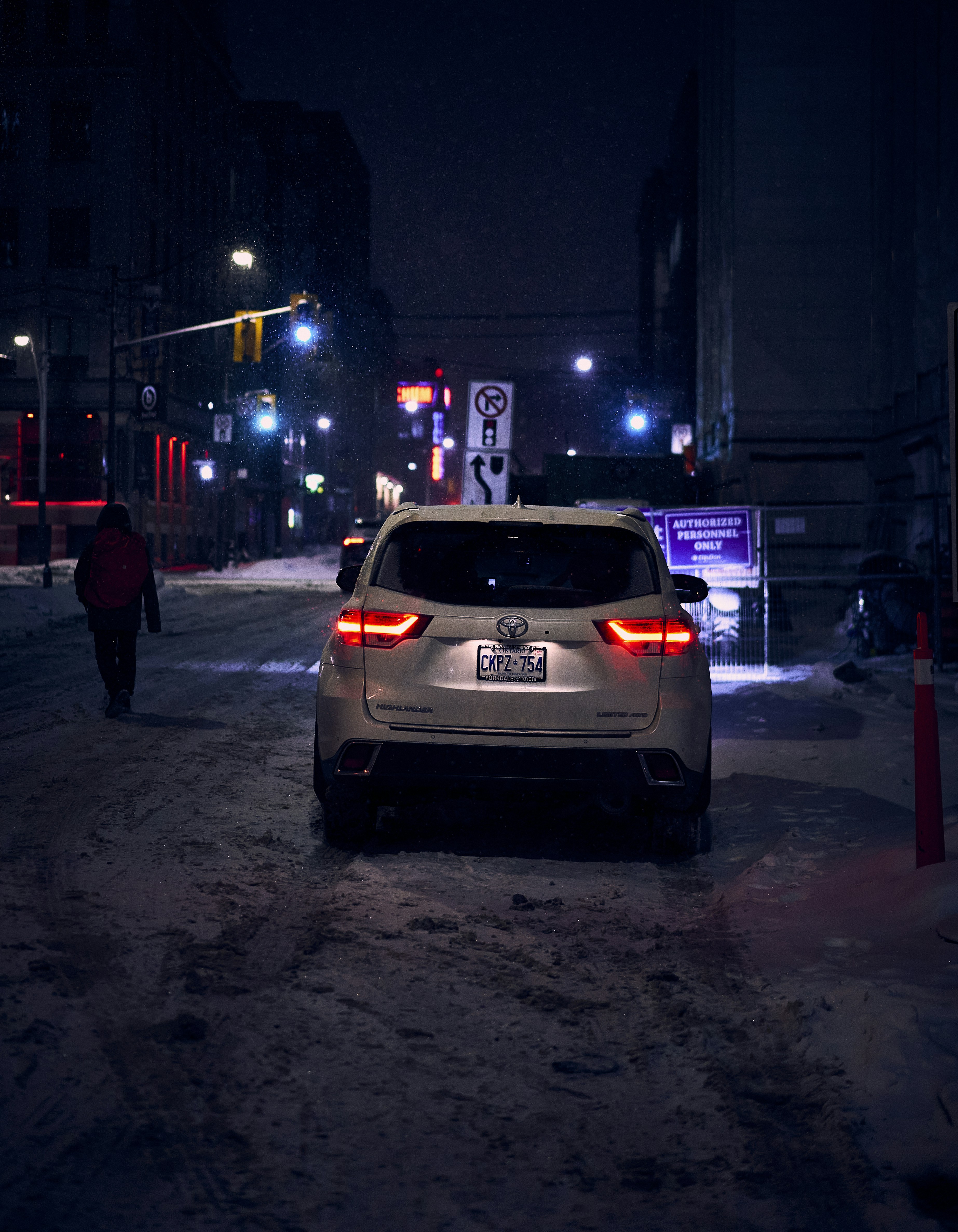 a car parked on a snowy street at night
