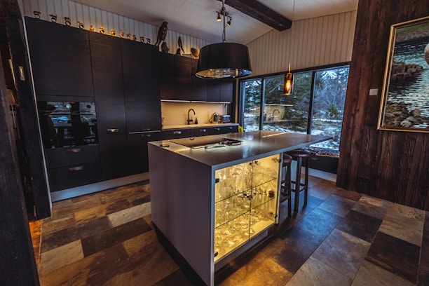 a kitchen with a large island with a glass door