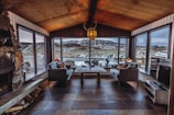 Cozy high-end chalet living room freshly cleaned with sparkling windows and polished wooden floors.