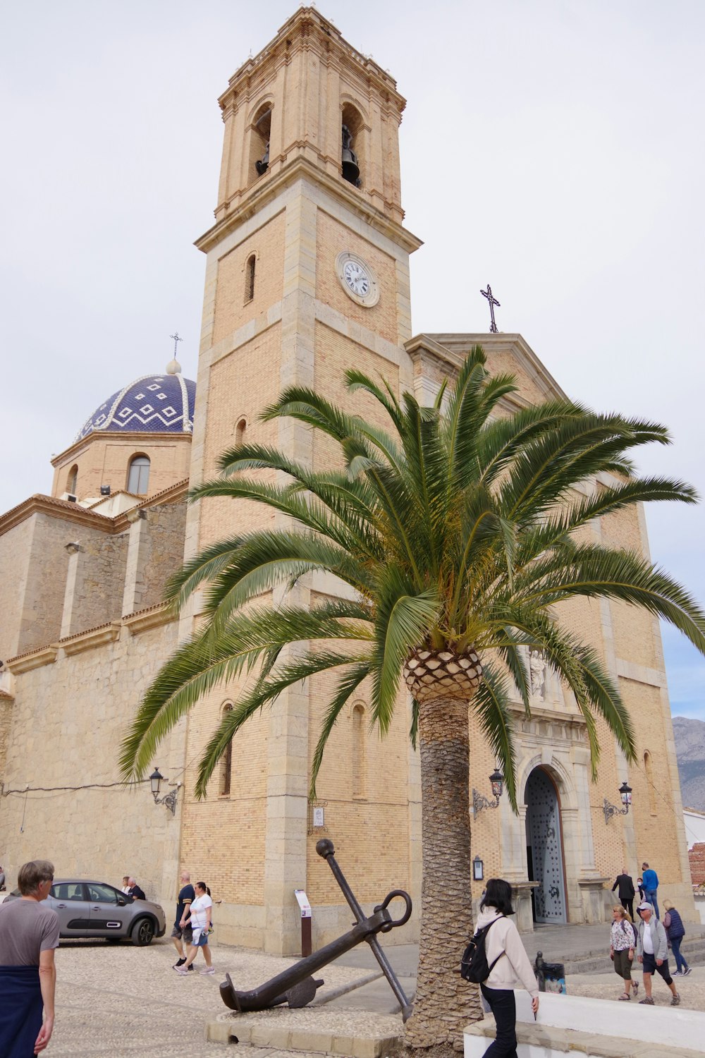 a palm tree in front of a church