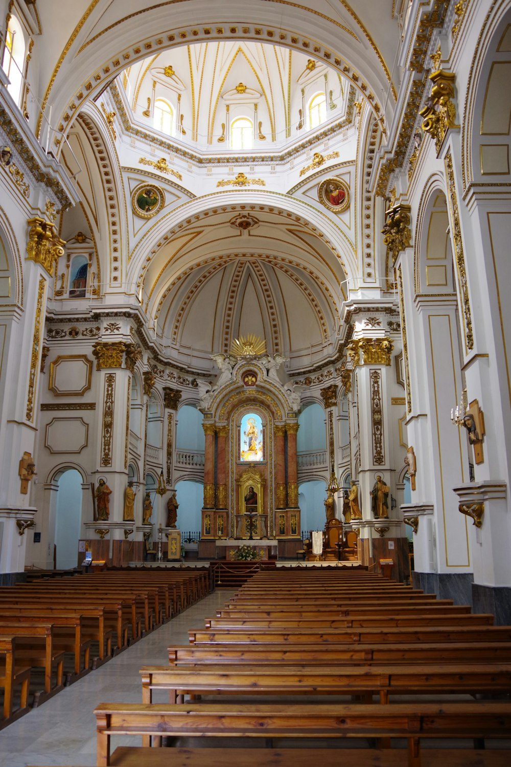 the inside of a church with wooden pews