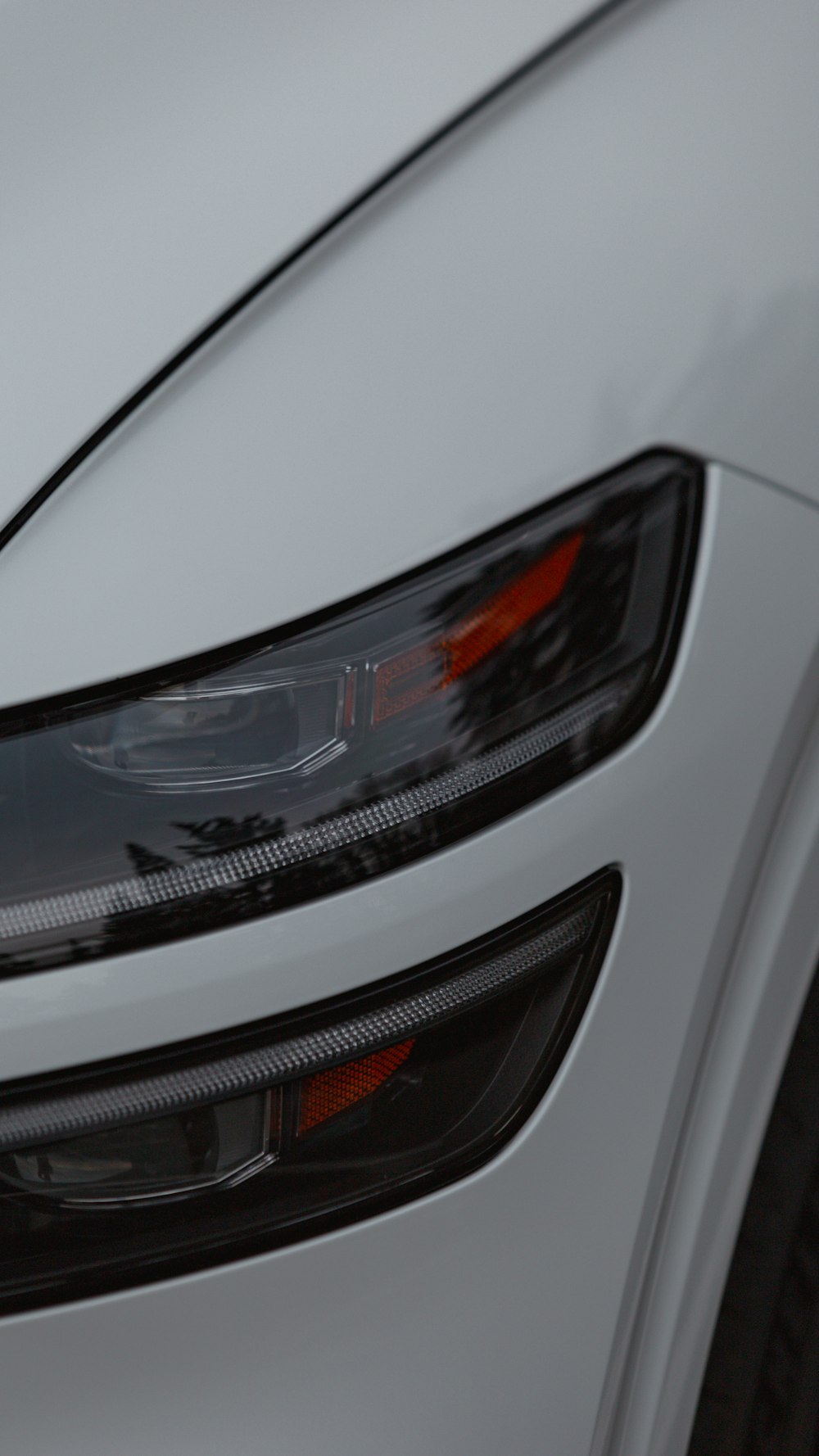 a close up of the front of a white car