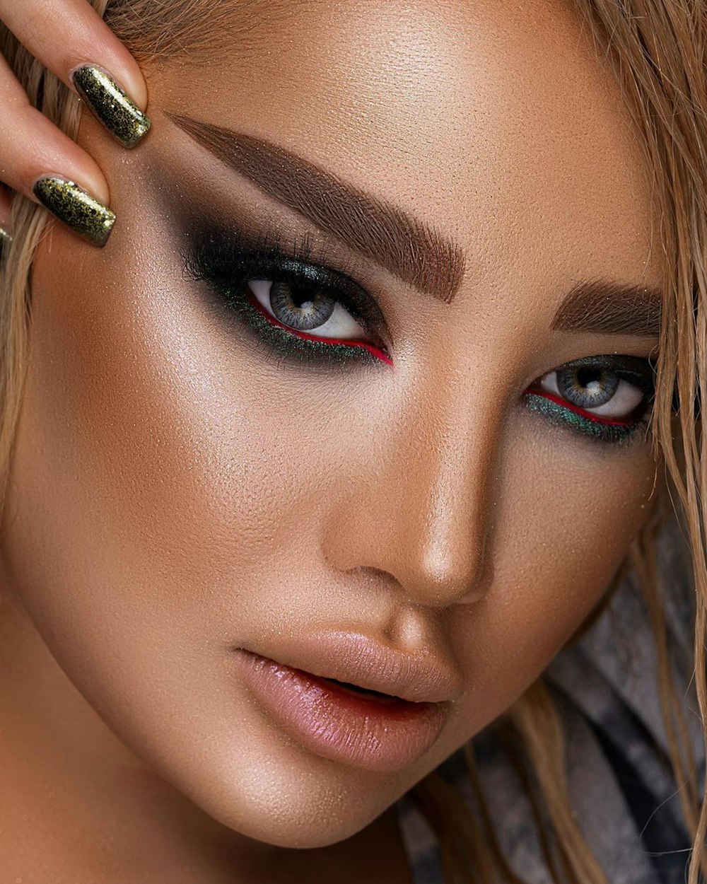 a close up of a woman's face with makeup