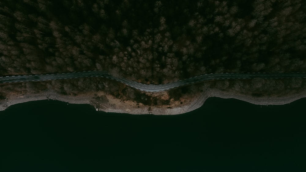 an aerial view of a road going through a body of water