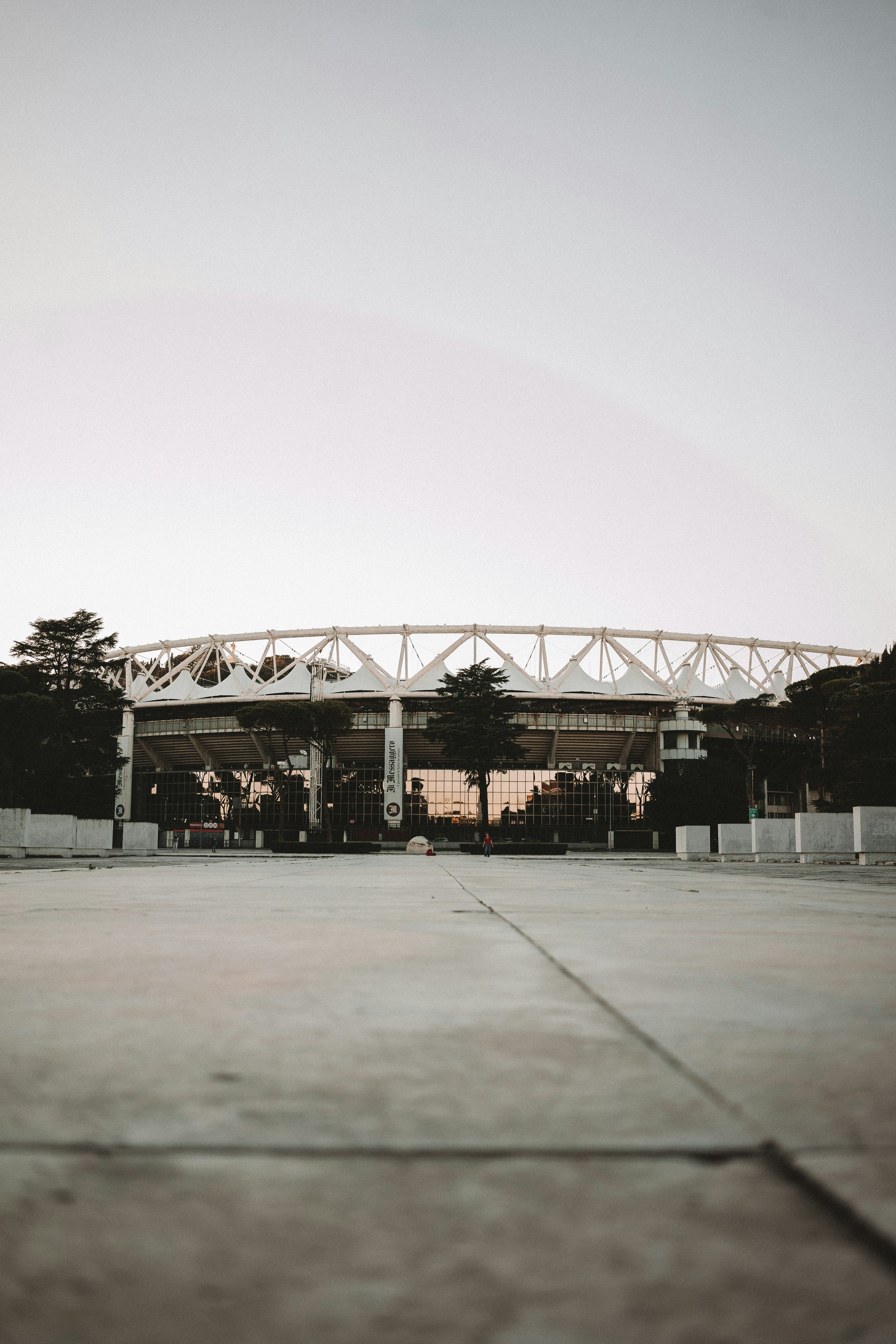 an empty parking lot with a building in the background