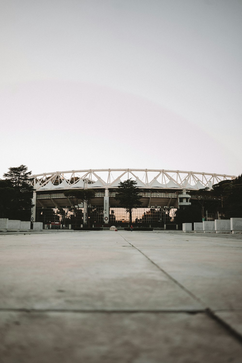 an empty parking lot with a building in the background