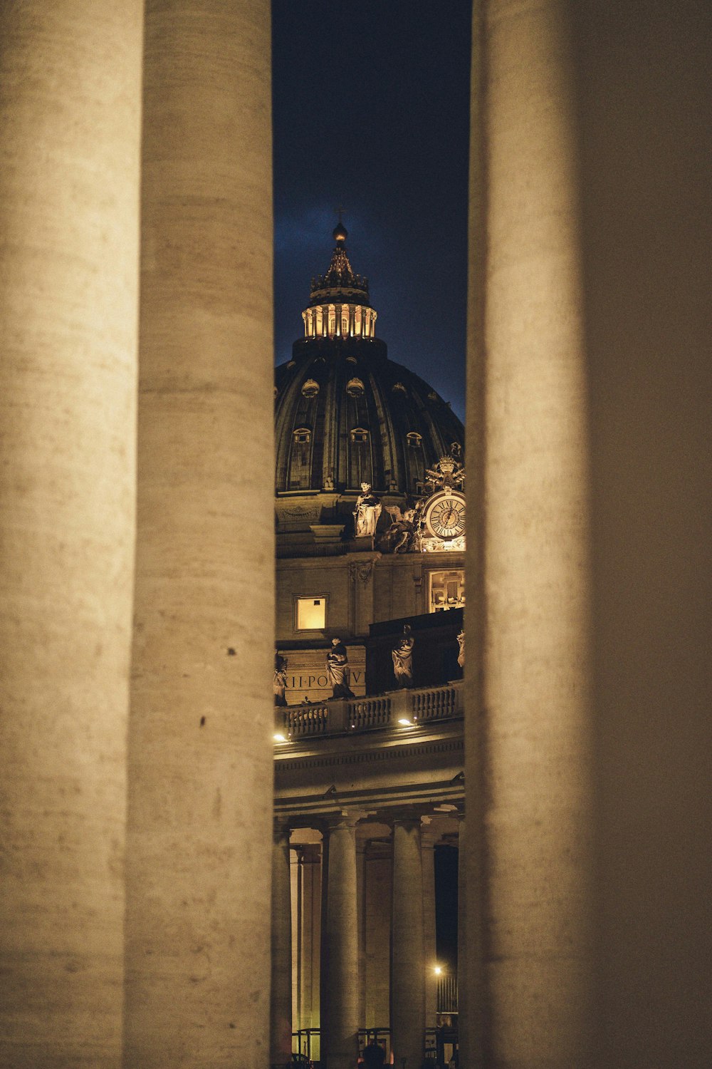 a view of a building through some pillars