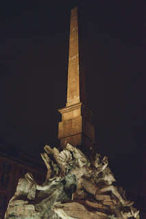 A striking fusion of Viking and Egyptian symbols carved into ancient stone, glowing softly under moonlight.