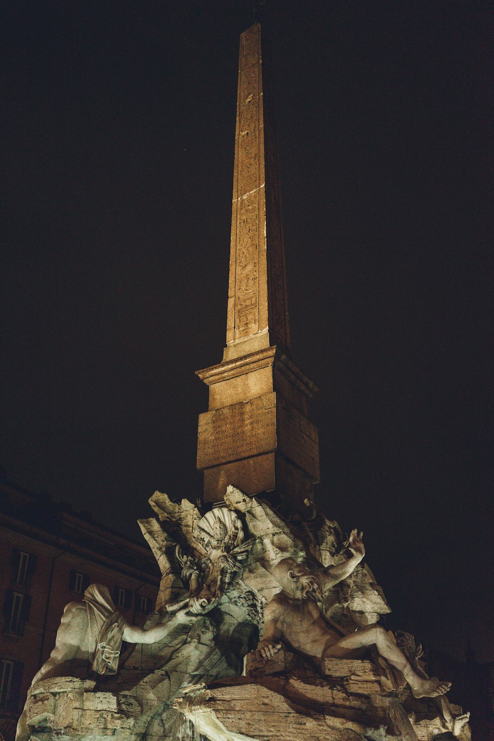 a very tall tower with a clock on it's side