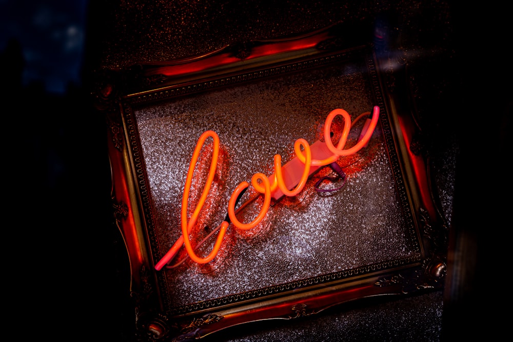 a neon sign that says love on it