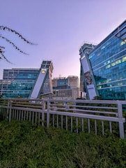 Modern office building with Dubai city skyline in background.