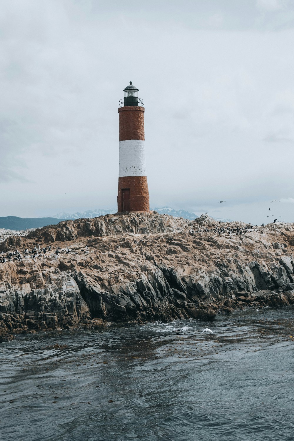 a light house sitting on top of a rocky cliff