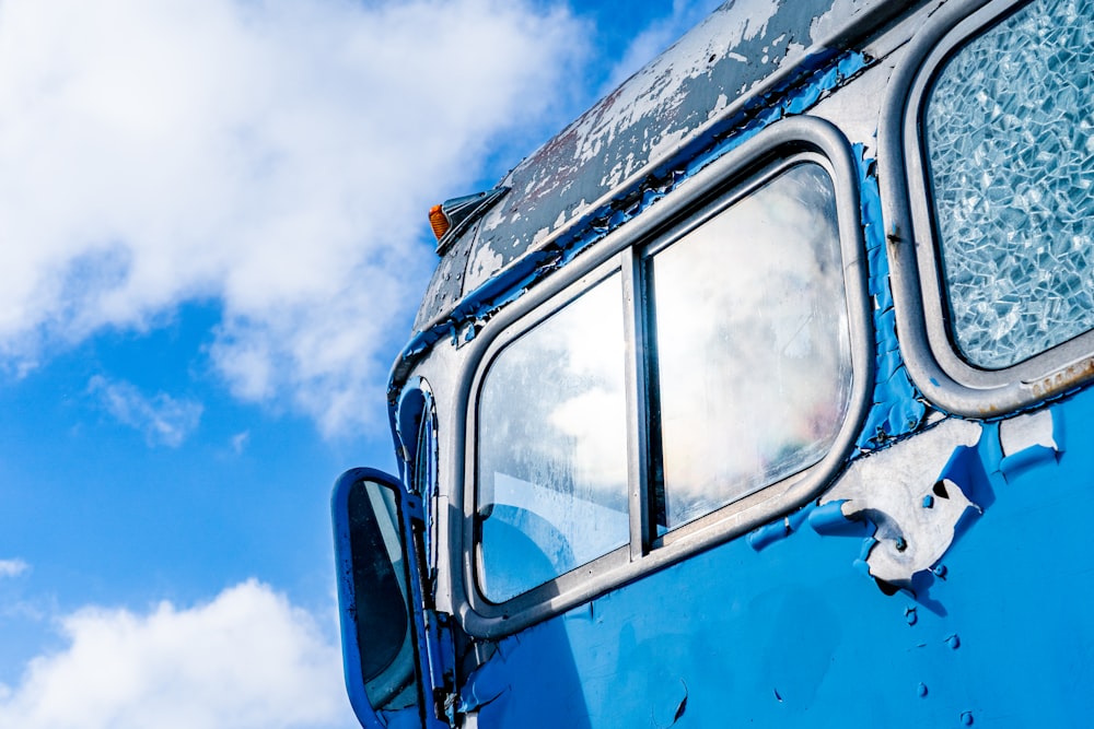 a close up of the side of a blue bus