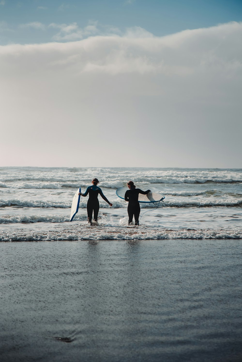 a couple of people that are standing in the water