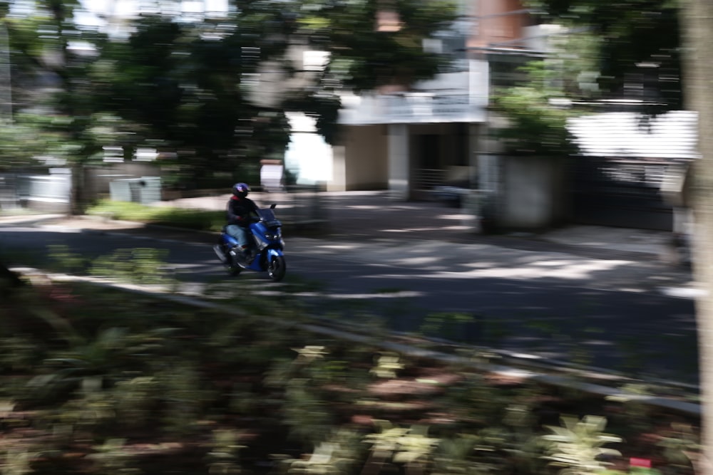 a person riding a motorcycle down a street