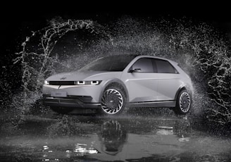 a white car is splashing in the water
