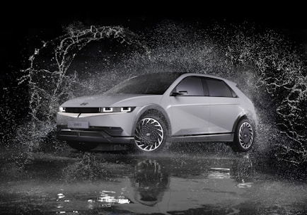 a white car is splashing in the water