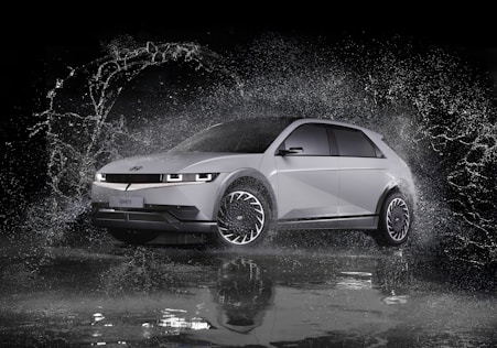 a white car is splashing in the water